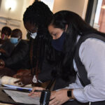 Documents being notarised. Chief Operating Officer, Mrs. Michelle Todman Smith and Executive Assistant and Commissioner for Oaths, Mrs. Karina Del Rosario.